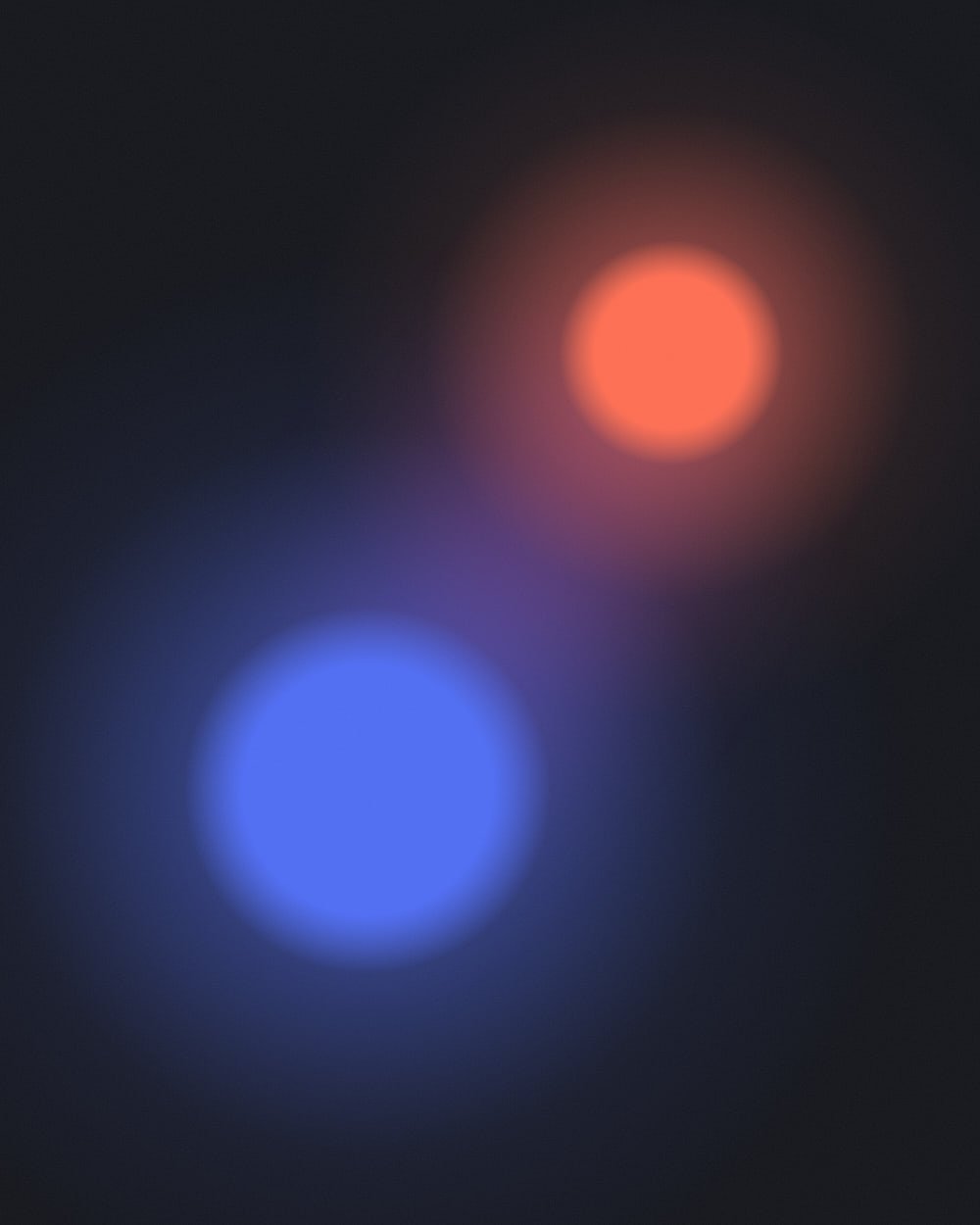 A large ultramarine orb at lower left and a smaller coral orb at upper right glow toward each other across a faint magenta haze on a dark field.