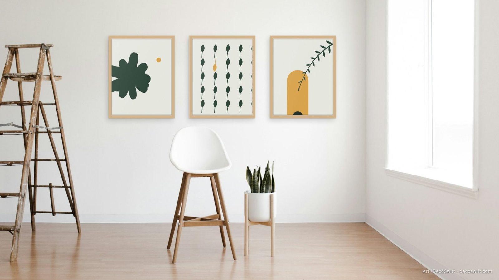 Video call background: Three Studio Botanica prints in oak frames on a white wall in a sunlit studio with a single chair and a plant.